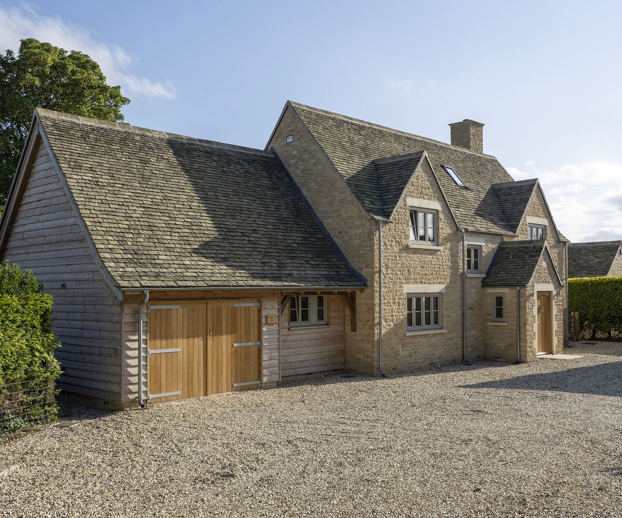 The front of a newly constructed oak frame self build with a garage building attached to the side