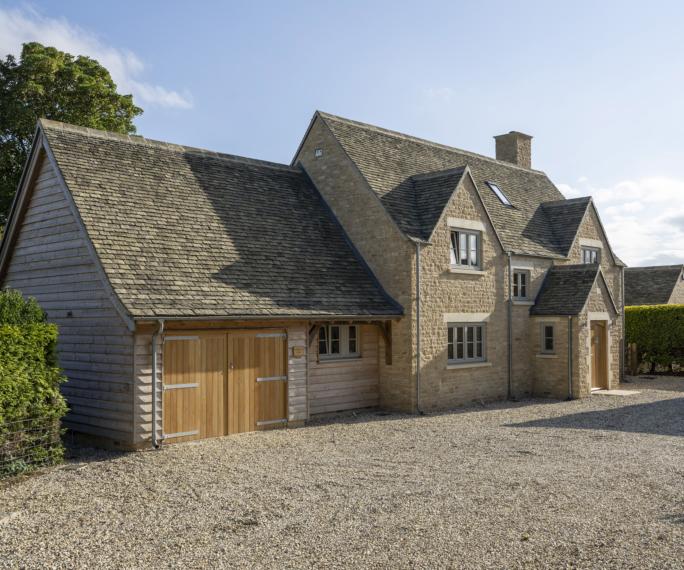 The front of a newly constructed oak frame self build with a garage building attached to the side