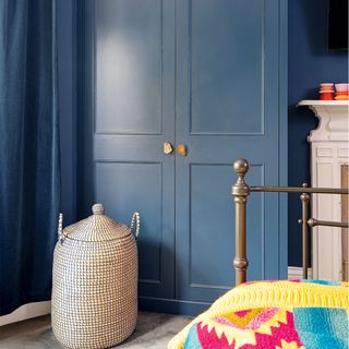 blue bedroom with painted wardrobes