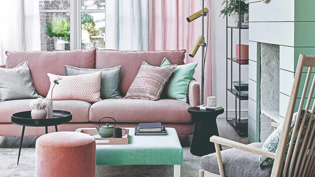 A living room with a pink sofa and mint green accessories