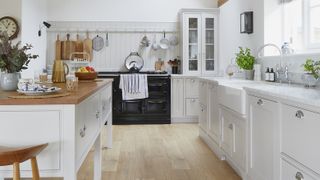 grey kitchen with black aga and wooden laminate flooring