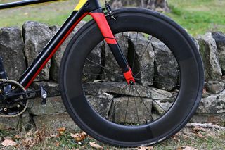 Andy Nicholl's black and red Orbea Hill Climb bike lent up against a small stone wall