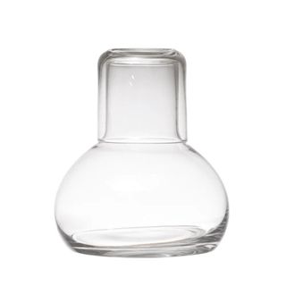 A glass decanter with a tumber lid