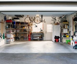 inside of garage with neatly stocked shelving units around outside and bikes hanging from ceiling