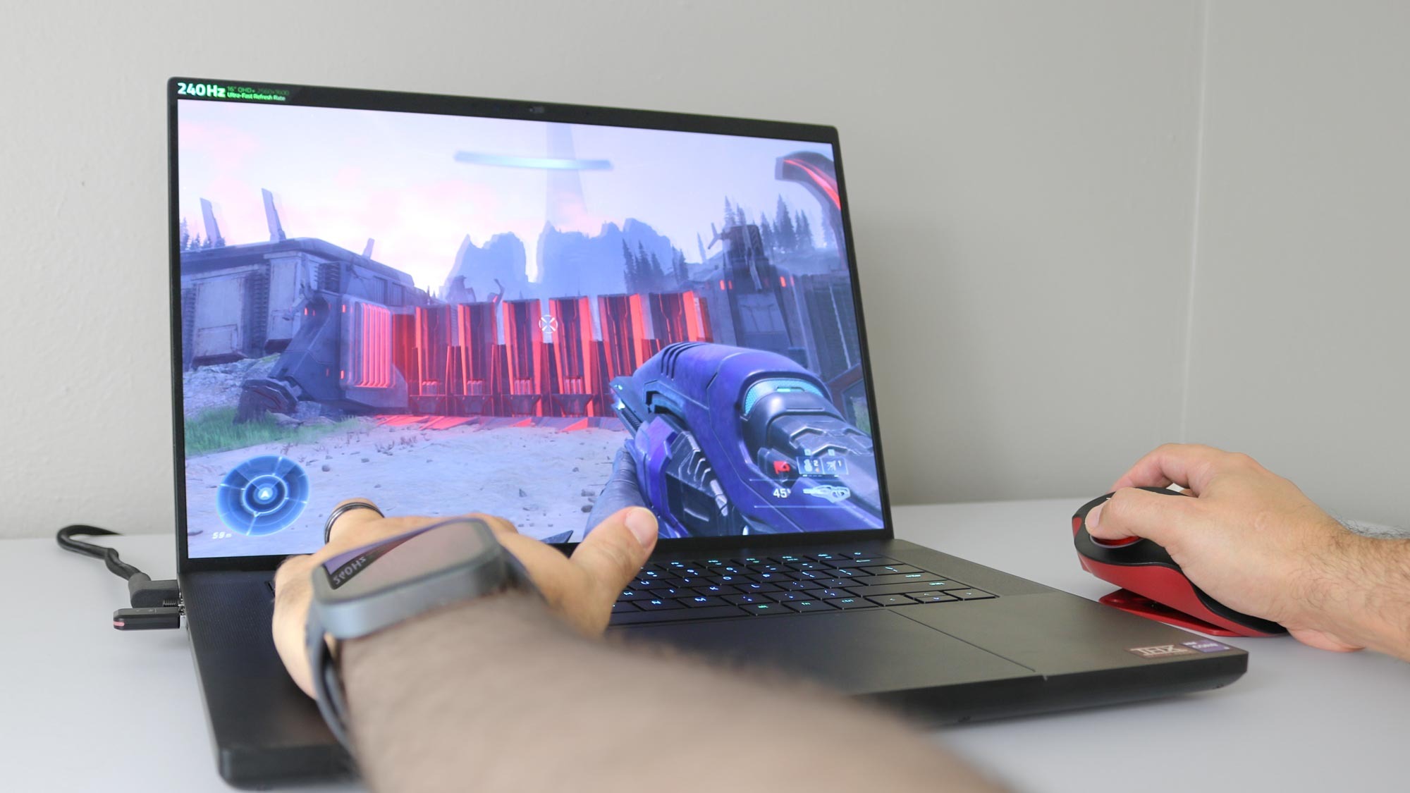 A closeup of someone playing PC games on a laptop with the GameBall Thumb mouse