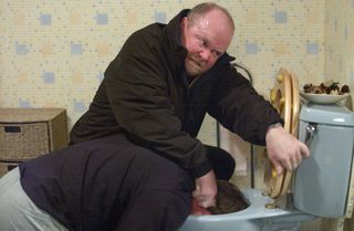 Phil Mitchell puts Ian Beale's head down the toilet