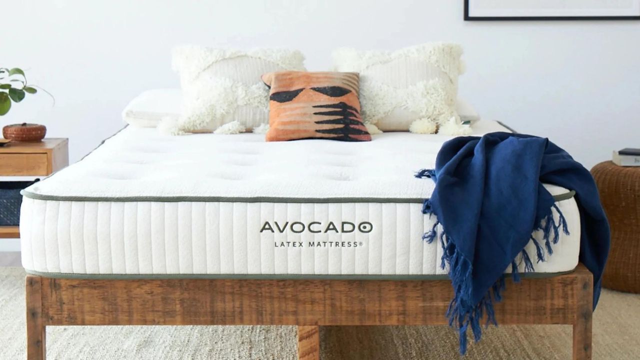 The Avocado Latex Mattress on a bed against a white wall.