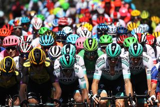 The Tour de France peloton is spread across the road