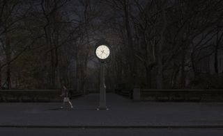 16-ft-tall aluminium timepiece at the entrance to Central Park at night