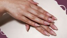 A womans hand with long bio sculpture nails in a glossy nude shade 