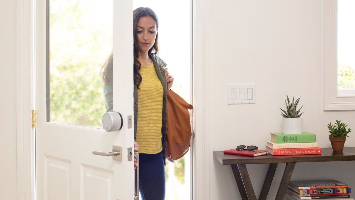 August Smart Lock Pro installed on a door that is being opened in a home