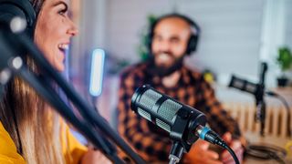 Man and women recording a podcast