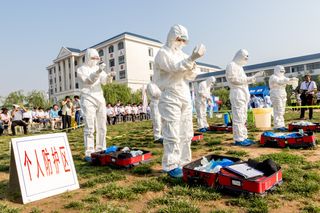 Health workers practice dealing with an outbreak of H7N9 avian flu on June 17, 2017, in Hebi, China.