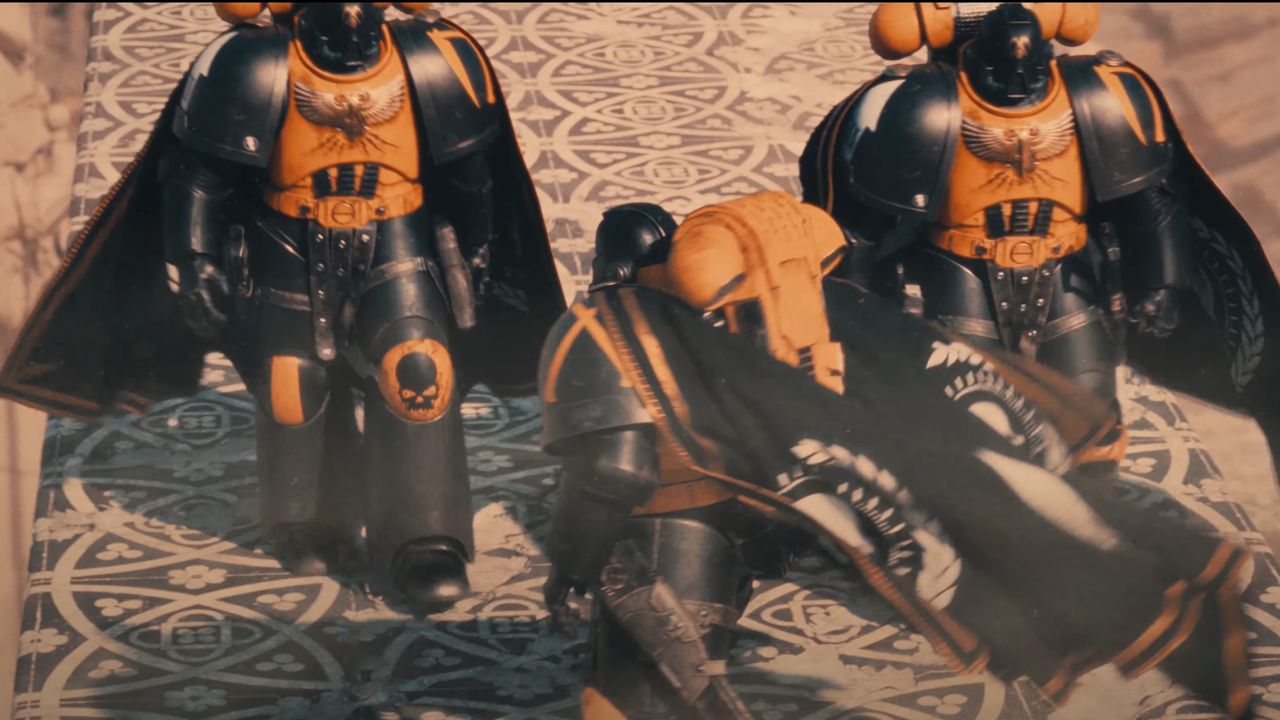 Three members of the Scythes of the Emperor chapter of Space Marines walking down a road, capes billowing in the wind.