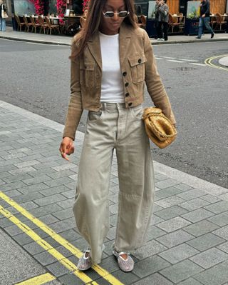 Mimi Orere in a cropped jacket, barrel jeans, and ballet flats.