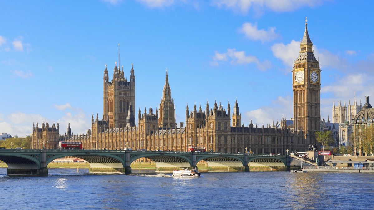 An image of the Houses of Parliament by the Thames on a sunny day