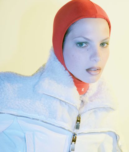 Woman wearing red ski cap photographed by Romain Duquesne