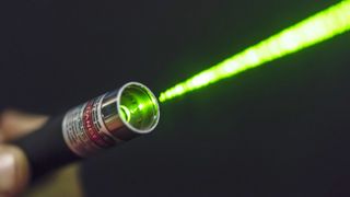 Green laser beam coming from a hand-held laser pointer