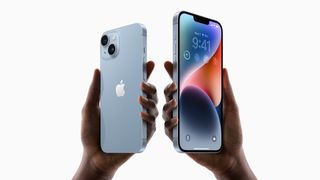 Two hands holding the blue iPhone 14 and iPhone 14 Plus