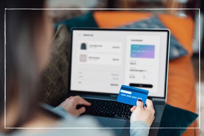 woman using a credit card to shop online on her computer