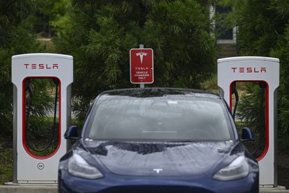 Tesla at a charging station.
