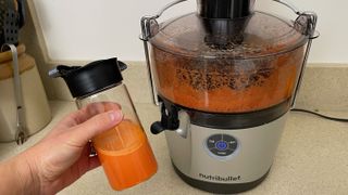 carrot juice in to-go cup after using the Nutribullet juicer pro