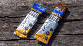 A pair of SIS energy bars on a wooden bench