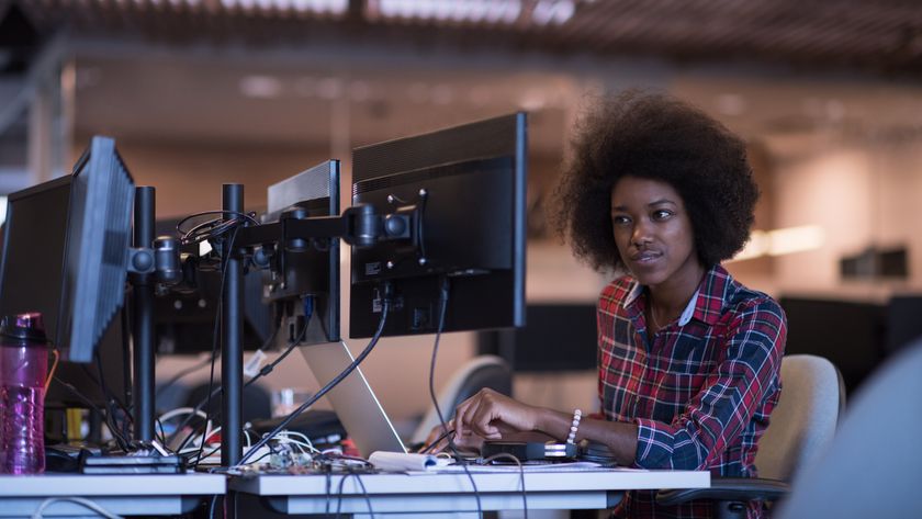 A person looks inquisitively at one screen of a dual monitor configuration, representing an article about the best monitor arms