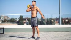 a man performing a kettlebell workout outside