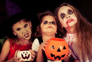 Kids go trick-or-treating on Halloween.