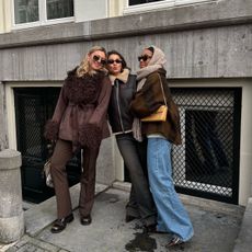 Three friends posing on the street