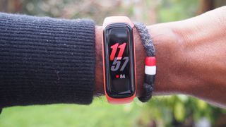 A Samsung Galaxy Fit 2 displaying the time, worn on someone's wrist