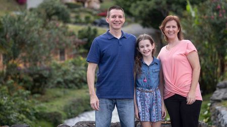 White family pose for the camera near their home in Panama