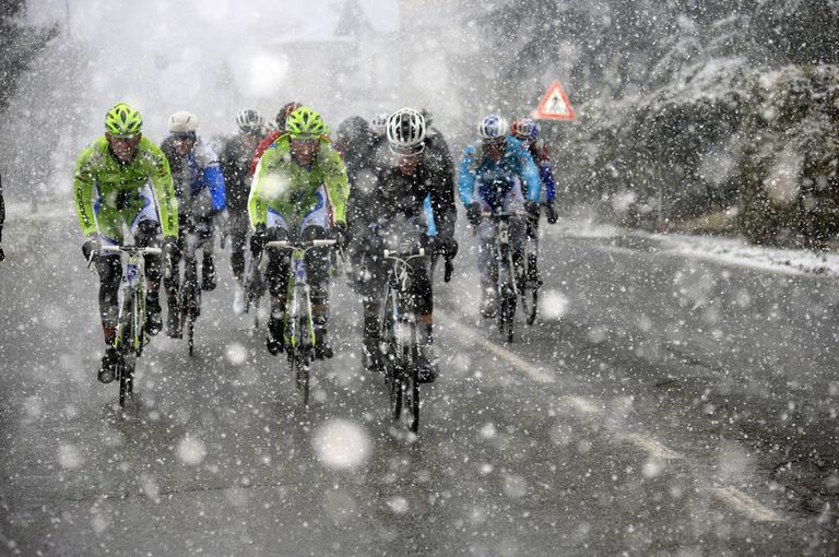 The peloton races through a snowstorm in the 2013 Milan San Remo