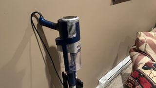 Shark Stratos Corded Ultralight standng against a wall
