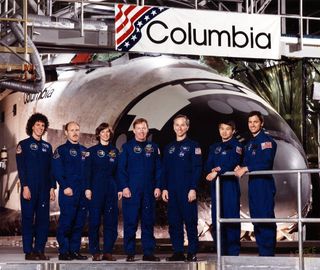 STS-50 Crew photo with commander Richard N. Richards and pilot Kenneth D. Bowersox, mission specialists Bonnie J. Dunbar, Ellen S. Baker and Carl J. Meade, and payload specialists Lawrence J. DeLucas and Eugene H. Trinh. The photo was taken in front of the Columbia Shuttle, which Dunbar helped to build.