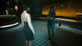 Cyberpunk 2077 Talent Academy - V is standing with her arms folded in front of Fiona