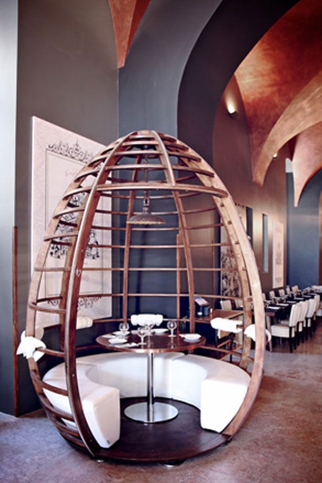 Interior view of the Museu da Cerveja. The focal point is the sitting area - open wooden construction in the shape of an egg, with a metal table in the center.