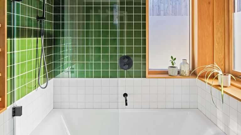 Bathroom with green wall tiles, white splashback tiles and matt black hardware