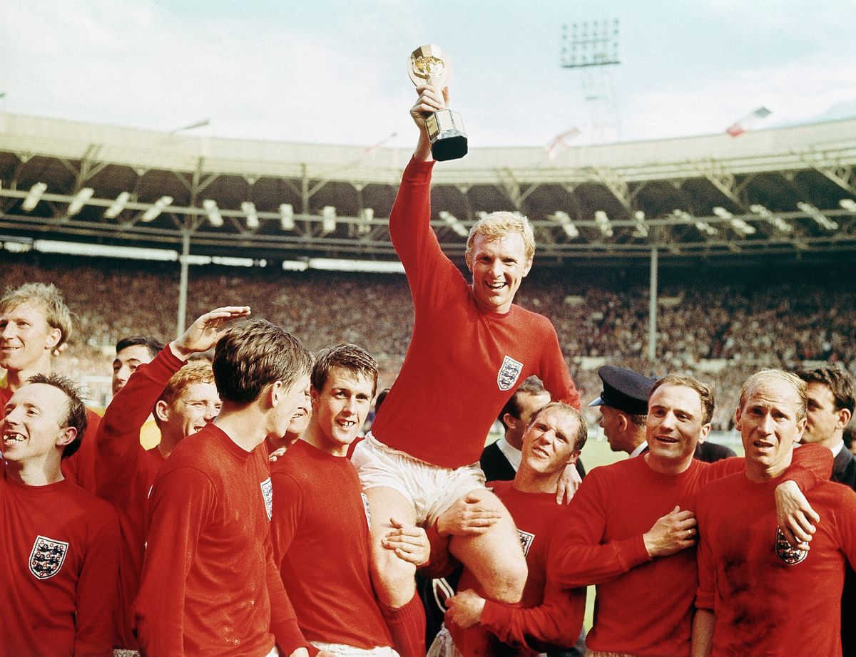 England captain Bobby Moore celebrates with his team-mates and the Jules Rimet trophy after the Three Lions&#039; World Cup win in 1966.