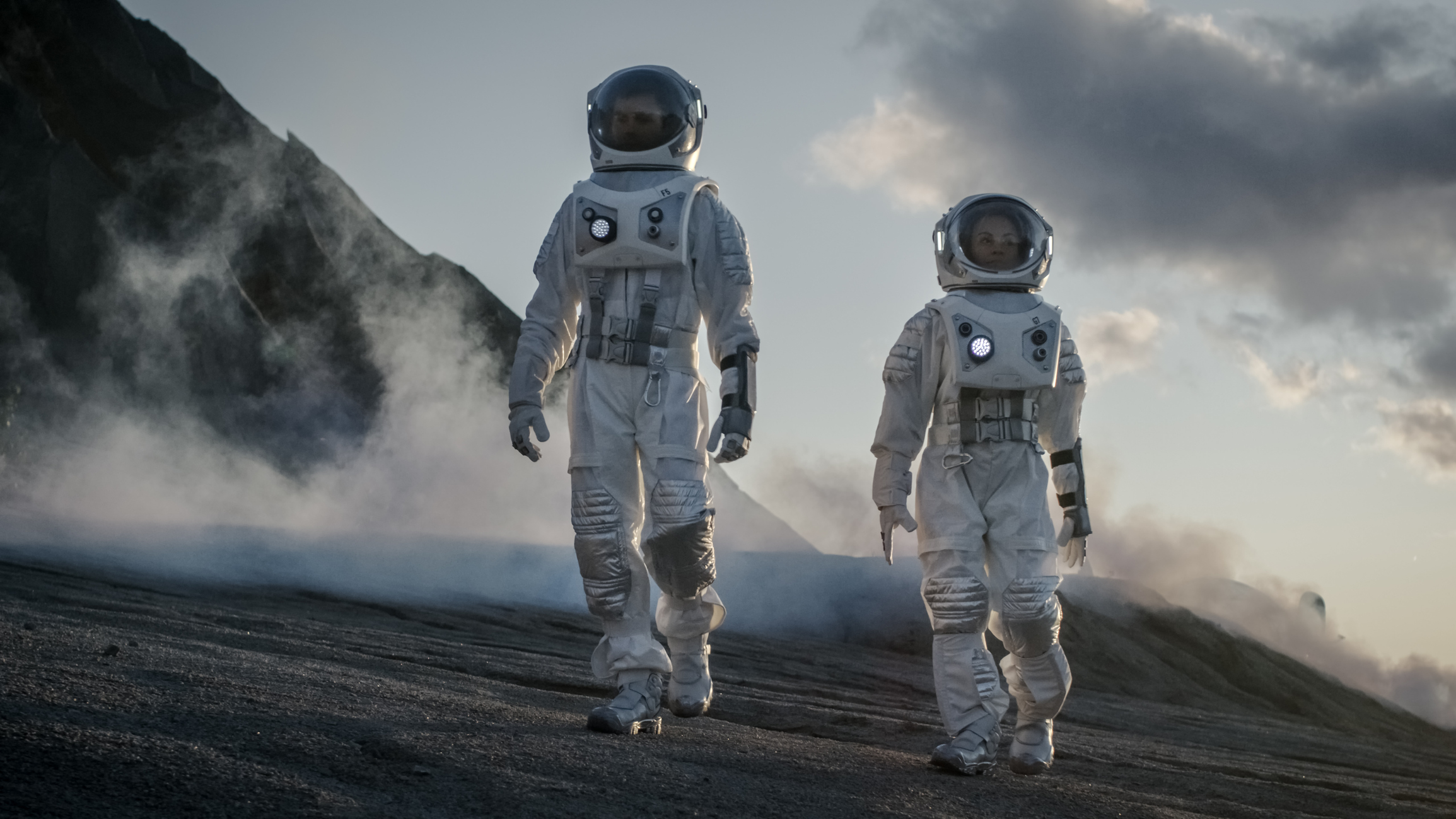 Two Astronauts in Space Suits Confidently Walking on Alien Planet, investing in space