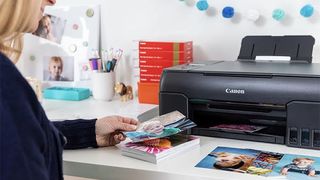 An image of someone using a Canon photo printer