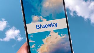 The Bluesky app logo surrounded by blue sky on the Bluesky signup screen.