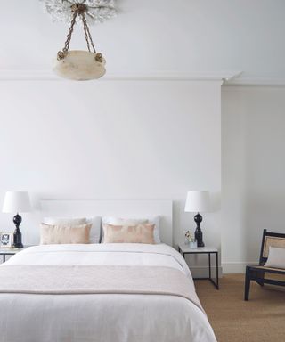 Minimalist white bedroom with jute carpet