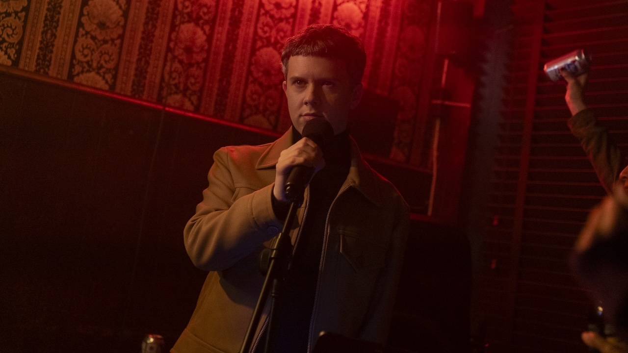 Cole Escola on a karaoke stage in The Girls on the Bus