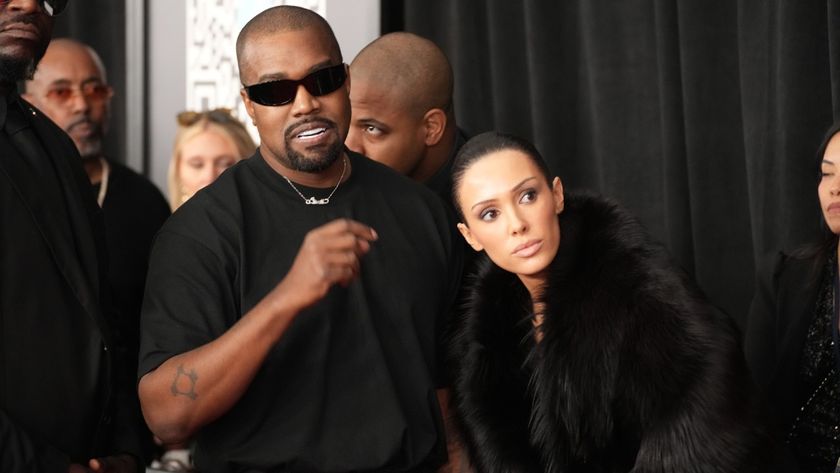 L-R) Kanye West talking and Bianca Censori wearing a black fur coat and looking to her right as they attend the 67th GRAMMY Awards at Crypto.com Arena on February 02, 2025 in Los Angeles, California. 