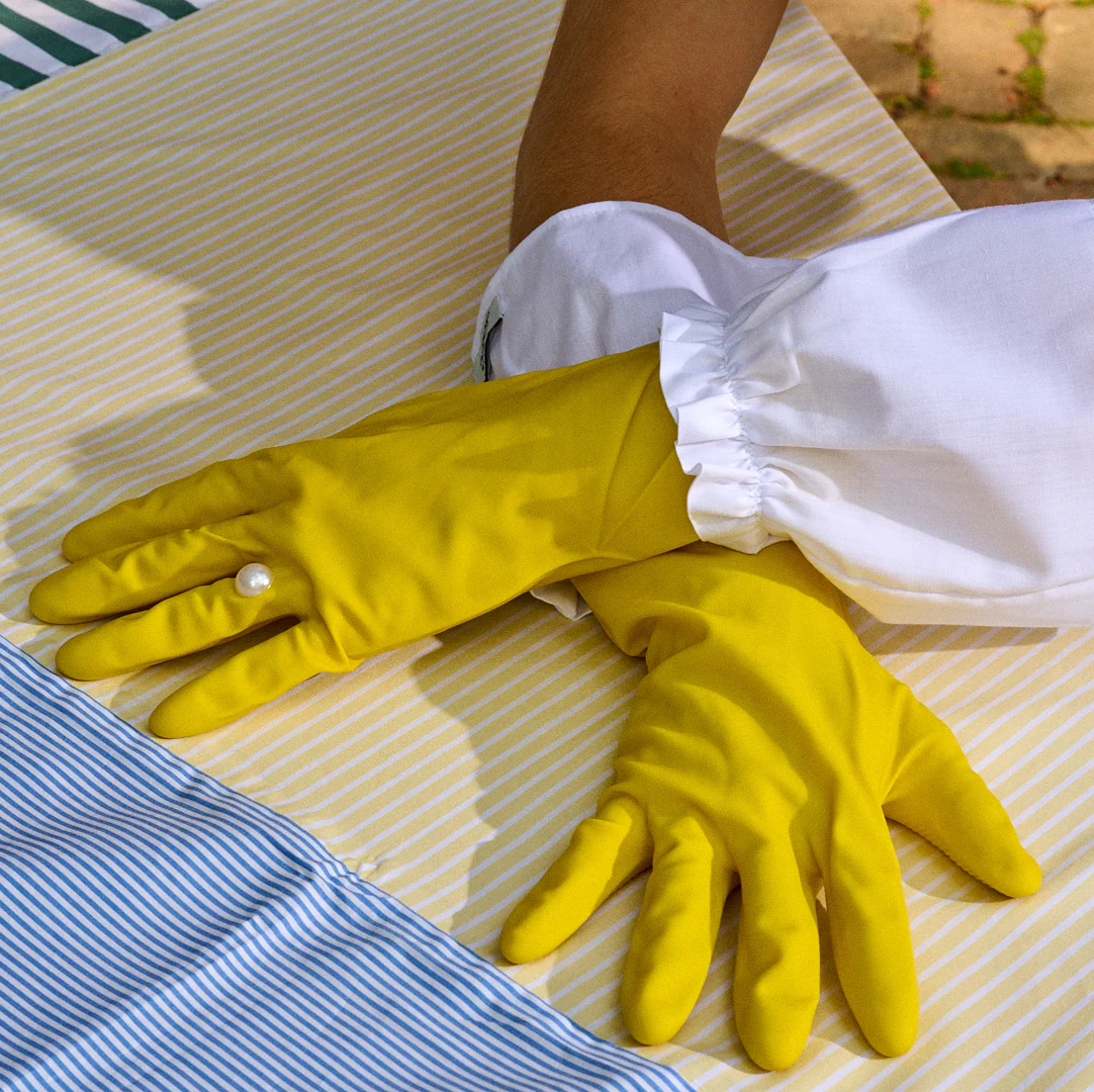 Gohar World's yellow rubber gloves with a faux pearl embellishment