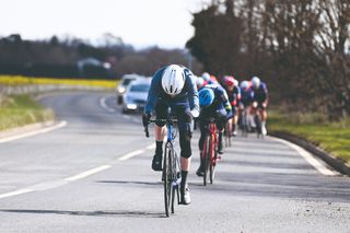 Male cyclist pushing on the pace at the front of a group