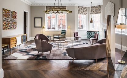 Set of mid-century modern furniture in brown velvet. It consists of two chairs, two armchairs, and a curved sofa. 