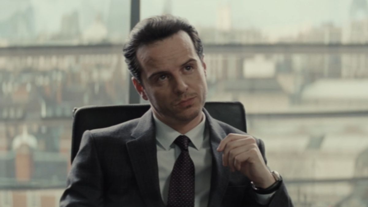 Andrew Scott sits at his desk with authority in Spectre.